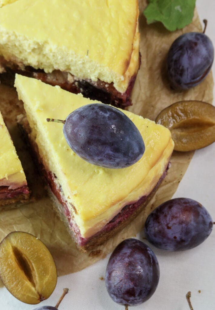 Plum cheesecake sliced and ready to be served as a protein rich plum dessert.